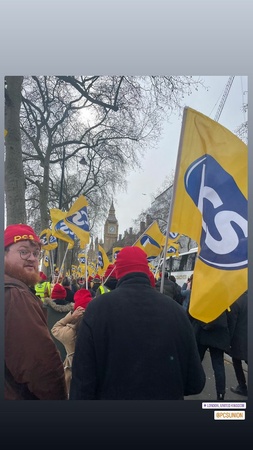 Image shows view in London towards Big Ben with many people holding PCS flags