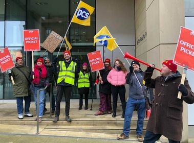 Image shows 9 PCS members with PCS flags and one blowing a vuvuzela